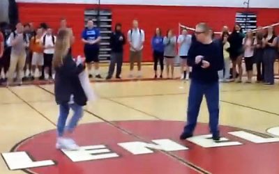 She Walks Over To Him On The Court With a Sign. The Sign Leaves Everyone Cheering!